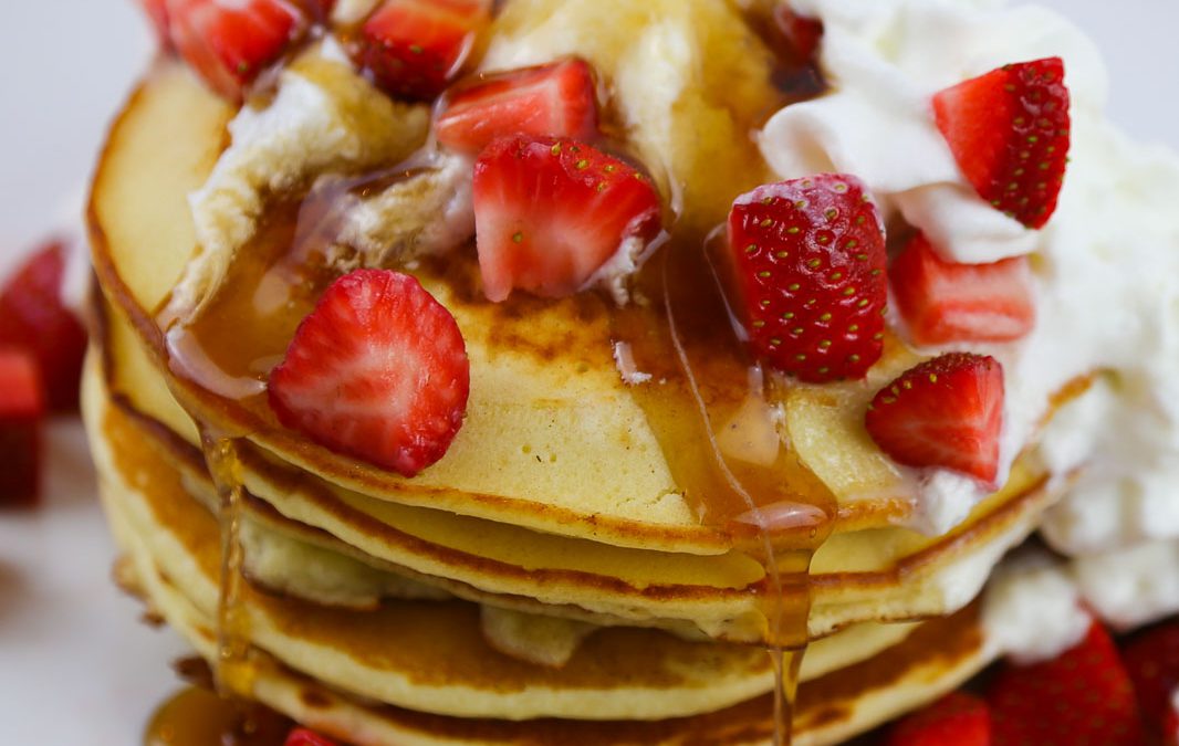 Pancakes Smothered in Strawberries and Whipped Cream for a Crowd