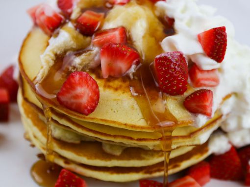 Pancakes Smothered in Strawberries and Whipped Cream for a Crowd